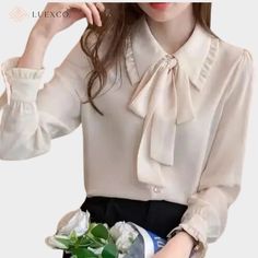 Indulge in luxurious elegance with this exquisite ribbon bow blouse. Constructed with delicate chiffon, this top features a draped lapel and a charming ribbon bow for added sophistication. Perfect for any occasion, elevate your style with this premium top. Attention! Sizes: In some cases, our clothing sizes may be Asian size, not US/European size. As a result, garments may run 1-2 sizes smaller than your usual size so please ensure that you have reviewed the sizing chart to confirm your specific measurements before your purchase to prevent unnecessary return of goods. Color Variation: While we aim to always provide you with the most accurate product descriptions and pictures possible, please understand that the actual color may differ slightly from the pictures shown online (due to the eff Chic Formal Chiffon Blouse, Feminine Party Blouse With Bow, Elegant Tie Neck Blouse For Semi-formal Occasions, Elegant Tie Neck Blouse For Semi-formal Events, Elegant Semi-formal Tie Neck Blouse, Elegant Spring Tie Neck Blouse, Elegant Chiffon Blouse With Ruffled Collar, Elegant Chiffon Blouse, Chic Party Blouse With Bow Tie