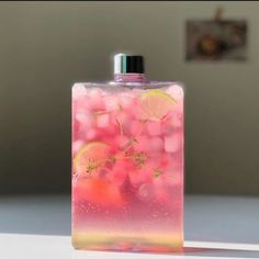 a flask filled with liquid sitting on top of a white table next to a wall