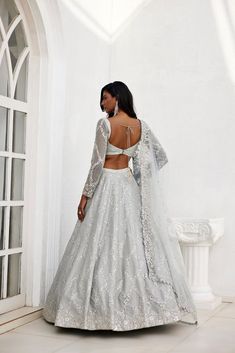 Grey dupion silk embroidered lehenga with mirror and zari detailing , paired with embroidered full sleeve blouse and tulle embroidered dupatta.From Chamee and Palak's The Romantics collection.DELIVERY TIMEPlease allow 8-12 weeks for your outfit to arrive.FABRIC DETAILSDupion Silk and Net Professional cleaning only. Party Cotton Silk Set With Sheer Dupatta, Tissue Silk Anarkali Set With Sheer Dupatta, Party Wear Cotton Silk Sets With Sheer Dupatta, Designer Tissue Silk Choli With Intricate Embroidery, Festive Long Sleeve Raw Silk Gown, Long Sleeve Raw Silk Gown With Intricate Embroidery, Long Sleeve Dola Silk Dress With Intricate Embroidery, Long Sleeve Organza Traditional Wear For Reception, Long Sleeve Lehenga For Wedding And Diwali