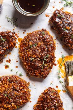 some meat patties are on a piece of parchment paper