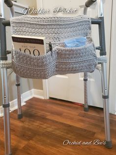 a crocheted chair with two magazines in the pocket and a magazine holder underneath it