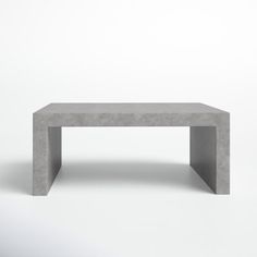 a concrete table sitting on top of a white floor