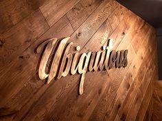 the sign on the wooden wall says,'virgintus'in cursive lettering