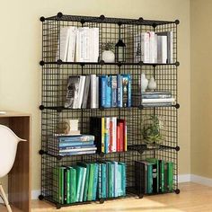 a book shelf filled with books next to a desk