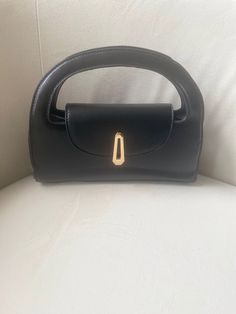 Elevate your fall wardrobe with the Margo Bag - the perfect accessory for any stylish outfit! This versatile bag offers both style and functionality, making it a fall must-have! PU Leather Imported Versatile Detachable Strap Gold Buckle Color: Black Approximate Measurements: 9.8"x4.7 On-the-go Baguette Bag With Double Handle, Fall Shoulder Bag With Gold-tone Hardware For On-the-go, Chic Box Bag With Detachable Handle For On-the-go, On-the-go Box Bag With Detachable Double Handle, Fall Shoulder Bag With Gold-tone Hardware, Black Baguette Bag With Detachable Strap And Top Handle, Black Baguette Bag With Detachable Top Handle, Elegant Shoulder Bag With Gold-tone Hardware For On-the-go, Black Travel Clutch With Top Carry Handle