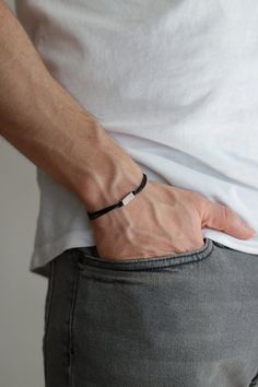 Bracelet for men - cord bracelet with a silver plated rectangle bead charm. The color of the cord in the picture is black and it is made of waxed cotton. The charm is silver plated. Clasp closure. You can request a different cord color from the colors shown in the last picture.The bracelet is 7 1/2 inches long (19 cm). If you would like a different length please choose your option at checkout.This bracelet is great as a gift for a man or a boy. All of our jewelry comes wrapped and ready for gift Minimalist Jewelry For Men, Men Minimal Jewelry, Men Bracelet Black, Black Mens Bracelet, Men Hand Jewelry, Male Jewelry Aesthetic, Men’s Bracelet, Bracelet Ideas For Men, Men’s Jewelry