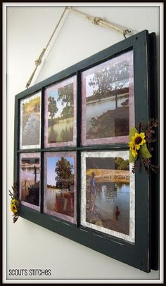 an old window is hung on the wall with flowers and sunflowers in it