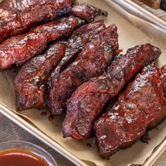 barbecue ribs and dipping sauce on a tray