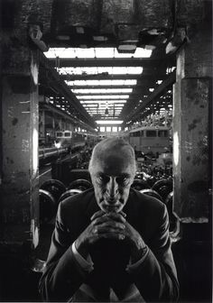 black and white photograph of a man in a warehouse