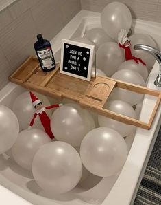 an elf is in the bathtub with balloons and a sign that says don't use