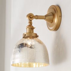 an antique style light fixture on a white wall