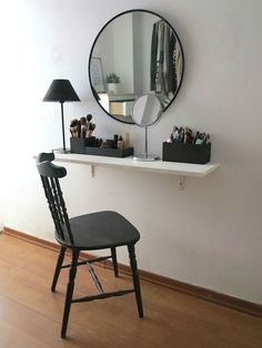 a chair sitting in front of a mirror next to a desk