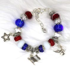 Fabulously patriotic bracelet feature Red White and Blue Beads, an America Charm, a USA charm and a Star charm. Nothing says I love America with more style! #pandorastylebracelets #Largeholebeads #America #charmbracelet #patriotic #flag #eagle #star #usa #heart #love #Muanobeads #uniquejewelry #blue #red #white #silver #rhinestone #handmadejewelry #MemorialDay #glass #july4th #special #mama #Veteran #etsysellers #beautiful #classy #elegant #patriot Red Adjustable Jewelry For Independence Day, Red Bracelets For 4th Of July Gift, Patriotic Bracelets For 4th Of July Gift, Patriotic Red Beaded Bracelets As Gift, Red Patriotic Jewelry For Independence Day, Red Beaded Bracelets For Independence Day, Independence Day Red Beaded Bracelets With Round Beads, Patriotic Red Bracelet For 4th Of July, Patriotic Beaded Bracelets For 4th Of July