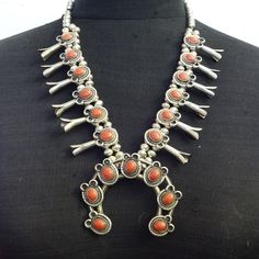 OLD PAWN RED MEDITERRANEAN CORAL SQUASH BLOSSOM NECKLACE DESCRIPTION:  With breathtaking specimens of old natural red Mediterranean coral, this necklace will be a valuable addition to your collection of fine vintage Southwestern and Native American jewelry. MEASUREMENTS:  Necklace measures 24" end to end Naja measures 3 1/2" x 3" Beads are securely strung on silver foxtail chain WEIGHT: 157.1 grams SIGNED: no STERLING:  unmarked, verified sterling silver Vintage Red Coral Necklace With Large Beads, Vintage Single Strand Red Coral Jewelry, Vintage Red Coral Round Bead Necklace, Native American Words, Vintage Sterling Silver One-of-a-kind Necklace, Jewelry Measurements, Unique Hand-strung Red Coral Necklaces, Cowgirl Jewelry, Squash Blossom Necklace