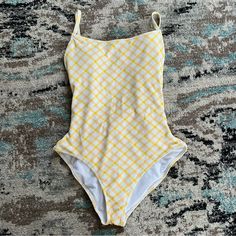 Jessica Simpson Afternoon Tea Checked Tie Waist Swimsuit. Size Medium. Have Fun In The Sun In This Cute Look From Jessica Simpson, A Checked One-Piece Swimsuit With A Scarf Tie At The Waist.Removable Cups. Lined. Moderate Bottom Coverage. Tie At Waist; Open Back. Pull-On Styling; Over-The-Shoulder Straps. Square Neckline. Stock Photos Are For Fit Not Color. Swimsuit Is Yellow And White. Nwot! I Took The Tags Off And Washed The Swimsuit Before Trying It On. Unfortunately It Didn’t Fit. My Loss Ca Summer Yellow Bodysuit For Pool, Yellow Bodysuit For Pool In Summer, Yellow Bodysuit For Summer Pool, Yellow Sleeveless One Piece For Summer, Yellow Bodysuit For Poolside Spring Occasions, Yellow Sleeveless One Piece For Vacation, Yellow Sleeveless One-piece For Summer, Sleeveless Yellow One-piece For Summer, Yellow One-piece Bodysuit For Summer