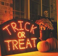 a lighted sign that says trick or treat