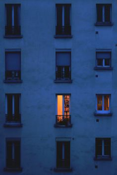 an apartment building with many windows at night