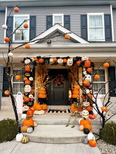 a house decorated for halloween with pumpkins and decorations