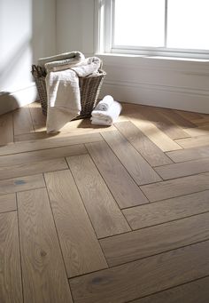 a bathroom with wood flooring and white towels