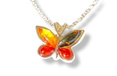 Embrace the feeling of lightness that this 925 sterling silver and Baltic amber butterfly pendant provides. This refined pendant captures the beauty of butterflies and the unique shine of amber. Material: 925 sterling silver Stone: Genuine Baltic Amber Stone dimensions: 2x 8x3, 2x 5x3 mm Item dimensions: 1.5 x 1.3 cm Color: Available in 2 colors. One is more orange while the other is more brown. Amber is a fossilized resin dating back millions of years. Amber is known for its beneficial properti Sterling Silver Butterfly Necklace For Formal Occasions, Formal Sterling Silver Butterfly Necklace, Orange Butterfly Jewelry For Gifts, Orange Butterfly Jewelry Gift, Orange Butterfly-shaped Jewelry Gift, Chakra Solar Plexus, Small Butterfly, Divine Timing, Art Deco Pendant