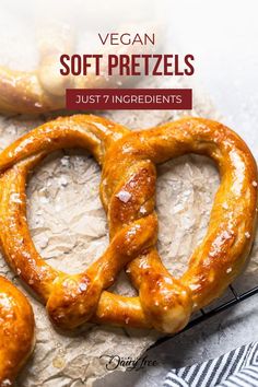 two pretzels sitting on top of a piece of paper next to a knife