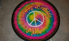 a peace sign cake with the words happy birthday mellow written in rainbow swirls