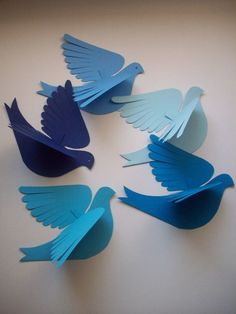 several paper birds are arranged in a circle