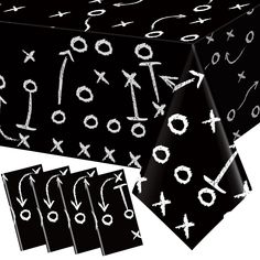 a black table cloth with white crosses and arrows on it