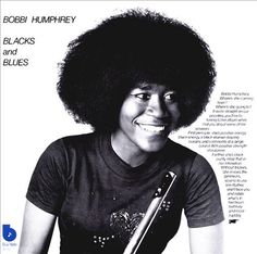 an advertisement for bobbi humphey's black and blues featuring a smiling woman holding a guitar