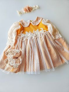 Beautiful christening dress, with vintage aesthetic. Perfect for christening day A beautiful, unique dress, with warm color and retro details. Our dresses are handmade, made with beautiful, soft pastel colors. The lining is pure cotton or viscoze for the baby to feel comfortable. We love classic design and timeless aestehetic. Only hand washing is recommended. Spring Baptism Dress With Lace Collar, Fitted Yellow Dress For Baptism, Yellow Fitted Dress For Baptism, Cream Baptism Dress With Lace Patchwork, Embroidered Long Sleeve Baptism Dress, Beige Dress For Baptism And Spring, Yellow Ruffle Dress For Baptism, Yellow Ruffled Dress For Baptism, Handmade Long Sleeve Dresses For Spring