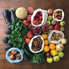 an assortment of fruits and vegetables laid out on a table