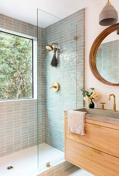 a bathroom with a sink, mirror and shower