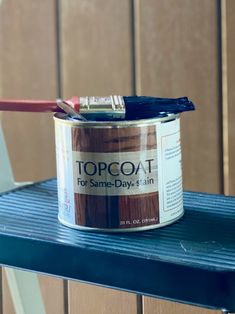 a can of paint sitting on top of a blue table