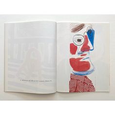 an open book with a drawing of a man's face in red, white and blue