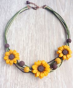 a necklace with sunflowers is shown on a table