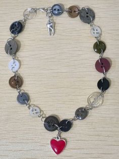 a bracelet with buttons and a heart on it