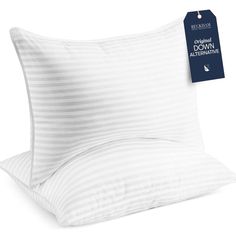 two pillows with white stripes on them and a blue tag hanging from the pillow case