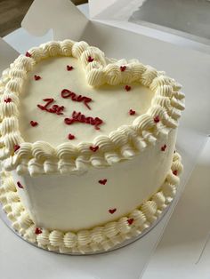 a heart - shaped cake with the words one love is displayed on a white table