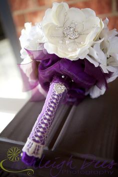 the bridal bouquet is purple and white