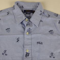 Polo Ralph Lauren Shirt Varsity Themed Button Up From Rl Winged Foot, Gothic P Graphics Tossed Icons Design Oxford Cotton Fabric Short Sleeve Collar Stays In Collar Approx. Chest Across Front: M: 23”. L: 24.5”. Xl: 26”. Xxl: 27.5” Brand New With Tags Pricing Is Fair And Quite Firm . Please Let Us Know If You Have Any Questions. Classic Collared Shirt With Logo Print, Classic Collared Tops With Logo Print, Classic Collared Top With Logo Print, Blue Shirt With Graphic Print And Spread Collar, Blue Graphic Print Shirt With Spread Collar, Blue Spread Collar Shirt With Graphic Print, Cotton Polo Collar Shirt With Logo Print, Collared Cotton Shirt With Logo Print, Collared Cotton Shirt With Logo