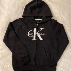 New W/Tags, Calvin Klein Logo Zip Front Hoodie, Size M (8/10), Black Calvin Klein Hoodie Sweatshirt For Winter, Calvin Klein Hooded Sweatshirt For Winter, Calvin Klein Winter Hoodie For Streetwear, Calvin Klein Hooded Winter Sweatshirt, Calvin Klein Cotton Sporty Hoodie, Black Calvin Klein Tops For Winter, Calvin Klein Black Winter Tops, Calvin Klein Black Top For Winter, Calvin Klein Cotton Hoodie With Long Sleeves