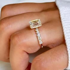 a woman's hand with a yellow and white diamond ring