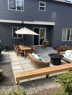 an outdoor patio area with furniture and umbrella