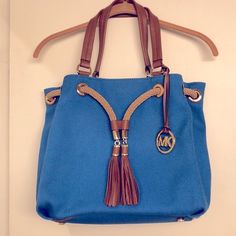 Michael Kors, One Of The Most Popular Handbag Designers Has Done It Yet Once Again With This Fabulous Marina Blue Canvas/Rope Detailed Handbag. Exterior Bag Details: Never Used - Excellent Condition > Color: Blue > Material: Canvas > Gold Metal Hardware > Double British Tan Leather Handles > Mk Metal Hangtag > Eight Circle Open Metal Rivets Surrounding Top Of Bag - The Front Two Rivets Has Michael Kors Name Printed On Them > Sturdy Braided Rope * Thru Open Rivets When Pulling Slightly Closes The Popular Handbag, Popular Handbags, Marina Blue, Leather Label, Braided Rope, Nautical Fashion, Blue Canvas, Leather Zipper, Canvas Tote Bag