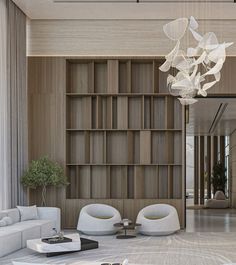 a living room filled with white furniture and a chandelier hanging from the ceiling