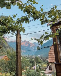 the mountains are in the distance with houses and trees around them, along with power lines