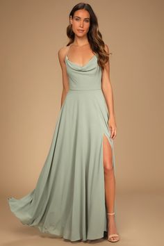 a woman in a long green dress with a slit down the side and one leg