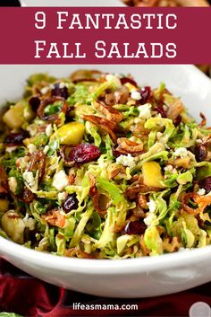 a salad in a white bowl with cranberries and nuts