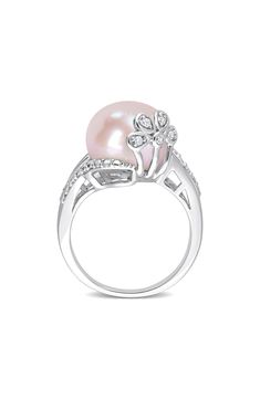 A polished sterling silver ring features a pink cultured freshwater pearl accented by dainty diamonds for luxurious shine. Pearl size: 12–12.5mm Total diamond weight: 0.05ct. Color: G–H Clarity: I3 Sterling silver/cultured freshwater pearl/diamond Imported Diamond Guide Elegant Pink Diamond Ring With Diamond Accents, Elegant Pink Diamond Ring With Accents, Elegant Pink Pearl Round Ring, Elegant Pink Ring With Diamond Accents, Pink Pearl Ring For Wedding, Pink Pearl Ring, Pearl Diamond Ring, Pearl Rings, Pearl And Diamond Ring