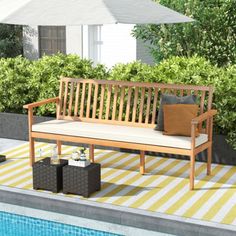 a wooden bench sitting on top of a patio next to a swimming pool with an umbrella over it